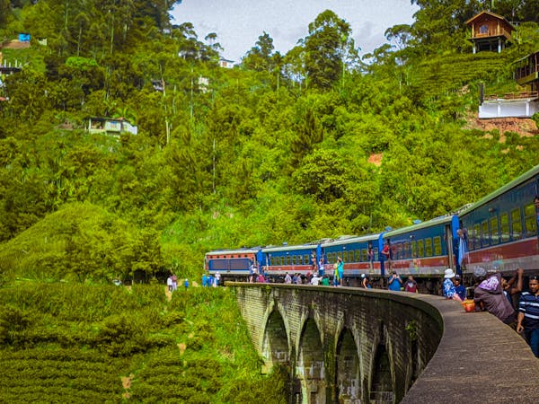 free-photo-of-a-train-traveling-over-a-bridge-with-people-on-it